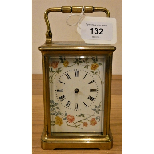 132 - A brass carriage timepiece, with floral decorated white dial, hands and key.