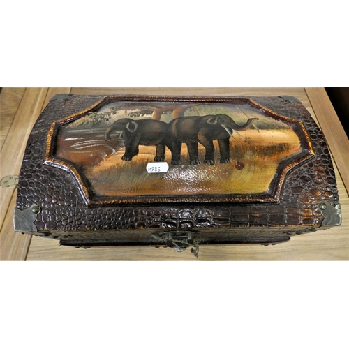 137 - A brass bound wood trunk, with a simulated crocodile skin finish, carry handles, the lid painted wit... 