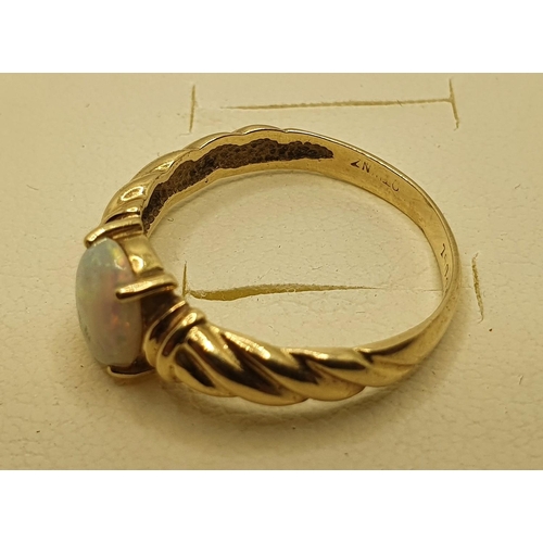 161 - A gold and opal set ring, stamped 750, size N 1/2, size 3 gms.