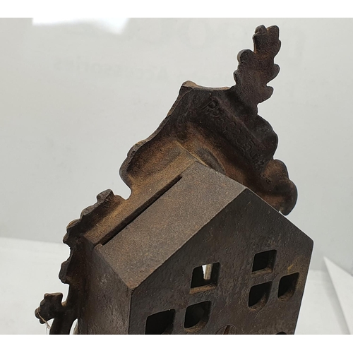 234 - An Edwardian cast iron BANK beehive money box, design registry number 502036, c. 1907, an Enchantica... 