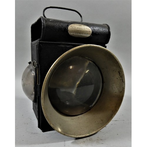 276 - An unmarked lamp, with burner, large clear front lens and two small clear side lenses.