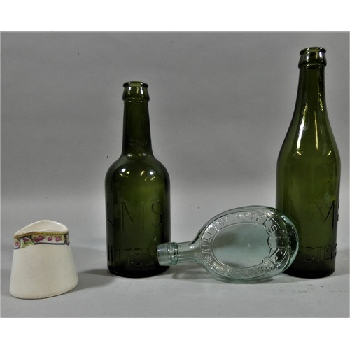 147 - Two LMS green bottles, a Midland Railway green bottle and a small LNER Keswick cream jug (4).