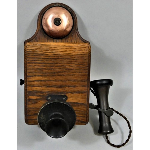 179 - A wooden cased wall telephone.