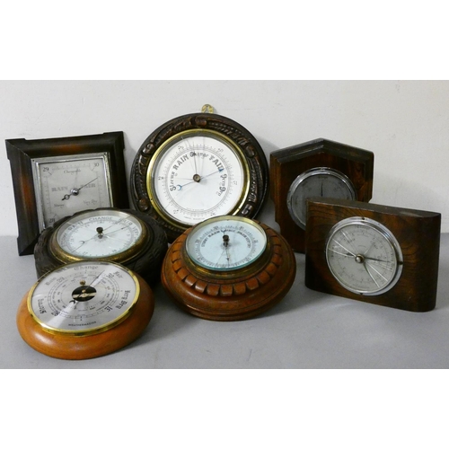 101 - A collection of six aneroid wall mounted barometers.