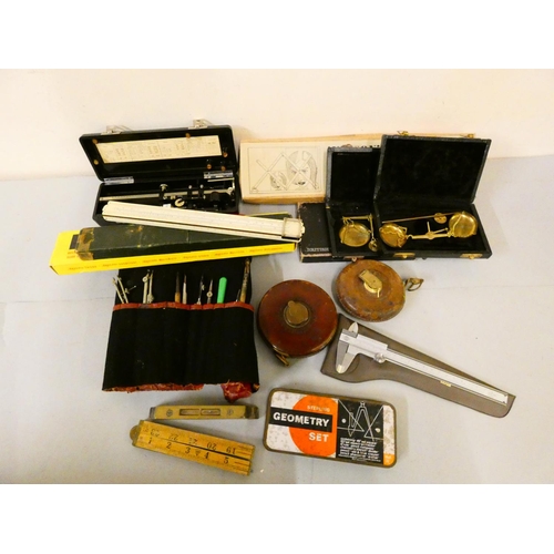 130 - A collection of instruments, including an Allbrit vernier tracing bar, slide rules, scales, measures... 