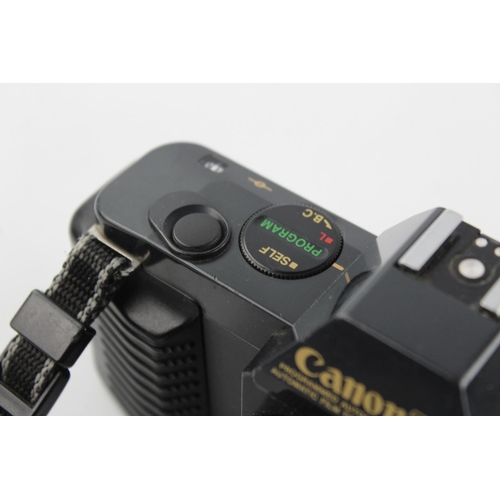 404 - Canon T50 SLR Film Camera w/ Canon FD 50mm F/1.8 Lens  The camera is WORKING and in a vintage condit... 