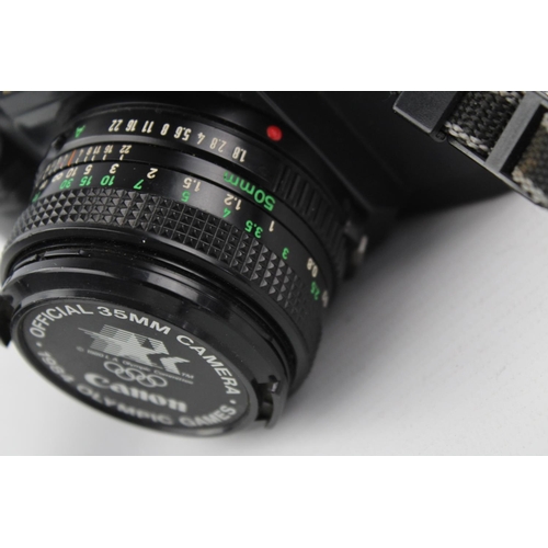 404 - Canon T50 SLR Film Camera w/ Canon FD 50mm F/1.8 Lens  The camera is WORKING and in a vintage condit... 