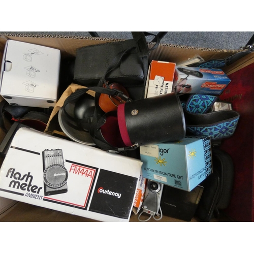 74 - A collection of camera accessories in the three boxes, including flash units, tripods, lens cases et... 