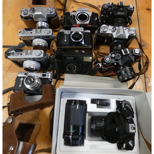 77 - A collection of cameras to include, Cosina SLR Zoom kit, cased, Zenit 12xP, E, II, B, 3M and Praktic... 