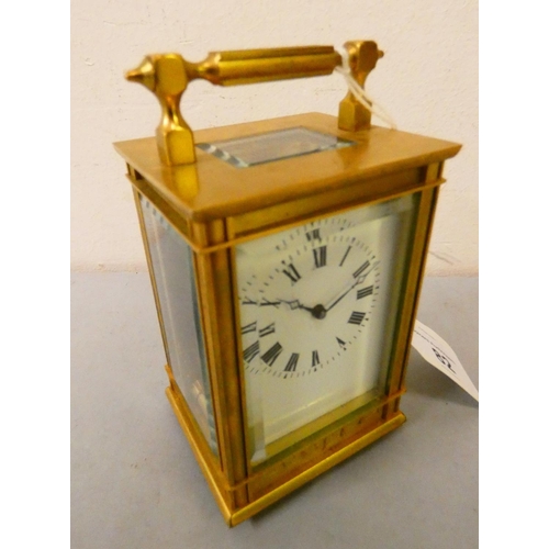 82 - A brass cased manual wind carriage clock with white enamelled dial and Roman numerals, movement stam... 