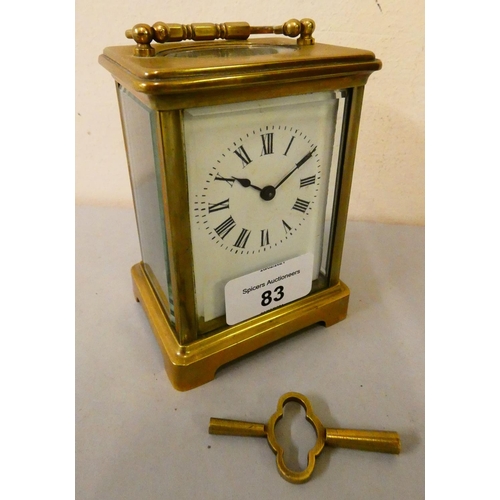 83 - A French brass cased manual wind carriage clock with white enamelled dial and Roman numerals.