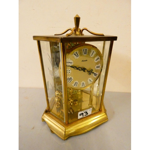 93 - A hexagonal brass cased Kundo mantle clock, together with a Kundo anniversary clock. (2)