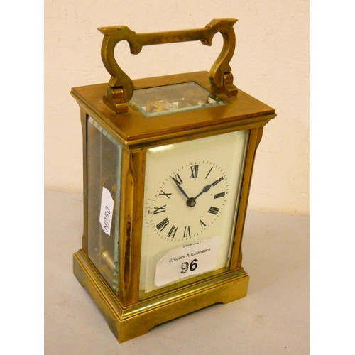 96 - A brass cased manual wind carriage clock with white enamelled dial and Roman numerals, stamped ACG t... 