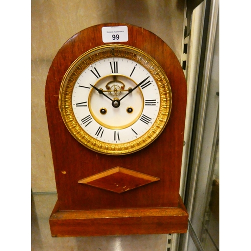 99 - A mahogany cased mantle clock with domed top, white enamelled dial, and Roman numerals.
39cm tall.