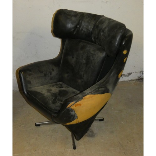 423 - A child's wing back swivel armchair, in the style of G Plan chair, in need of restoration.