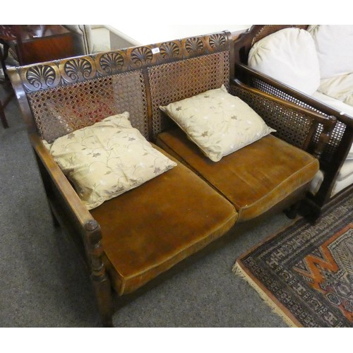 435 - A Bergere settee with mahogany frame, carved symbols along the top rail, mustard seat cushions.