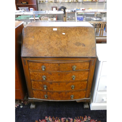 440 - A burr walnut bow fronted writing bureau, the fall front with inset skiver and fitted interior, over... 