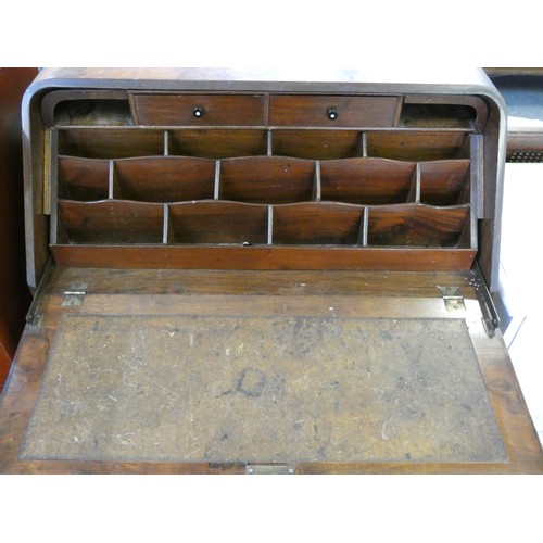 440 - A burr walnut bow fronted writing bureau, the fall front with inset skiver and fitted interior, over... 