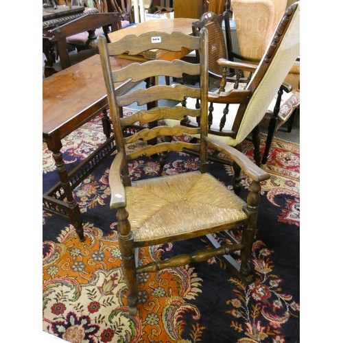 446 - A rush seated ladderback rocking chair and a Victorian upholstered mahogany armchair (2).