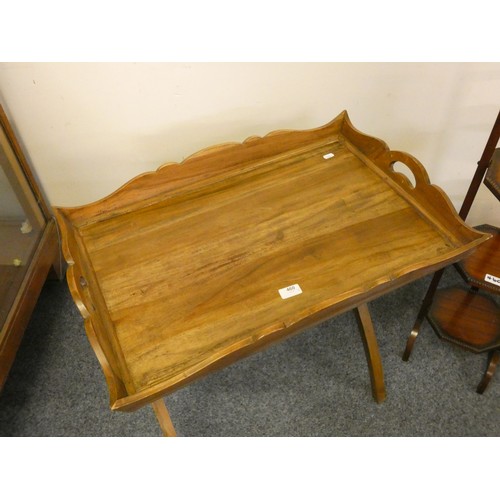 460 - A butlers tray with wavy border, raised on a folding X frame support, 72 x 48 cm and a three heigh f... 