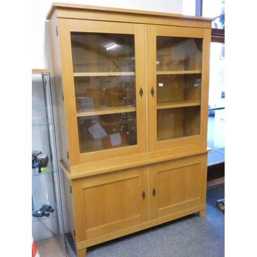 468 - A light oak display cabinet with two glazed doors over two cupboard doors, 150 x 46 x 209 cm.