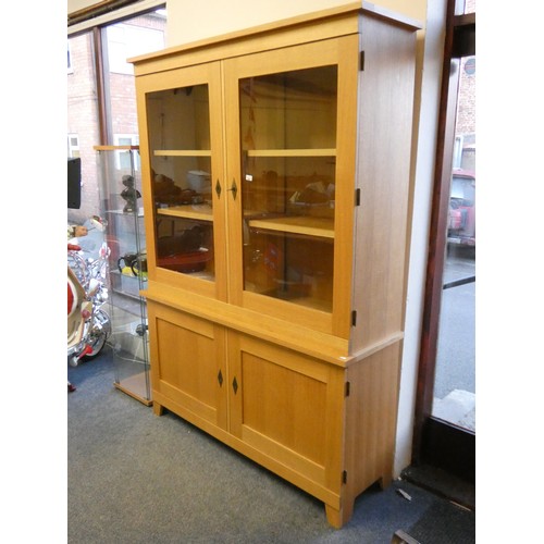 468 - A light oak display cabinet with two glazed doors over two cupboard doors, 150 x 46 x 209 cm.