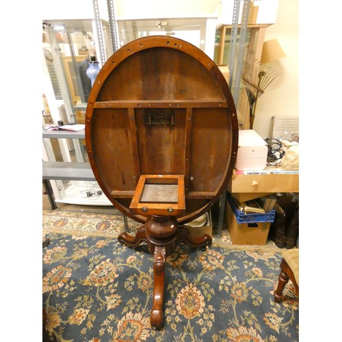 428 - A Victorian oval mahogany tilt top dining table, raised on a tripod base, 140 x 104 cm, together wit... 