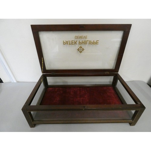 455 - A mahogany rectangular bijouterie cabinet, the hinged top painted Patek Philippe, 74 x 42 cm.