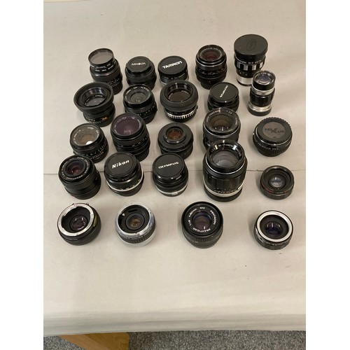 75 - A collection of camera accessories including, Olympus, Nikon, and Canon lenses, flash units, filters... 