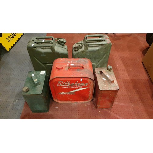 69 - A Silkolene 5.5 gallon oil can, an Esso petrol can and four other cans (6).