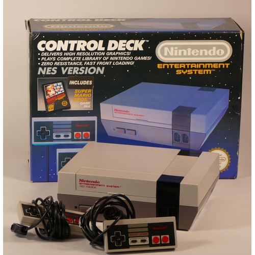 16 - Boxed Nintendo entertainment system with power supply, TV lead, two mini panel controllers, light gu... 