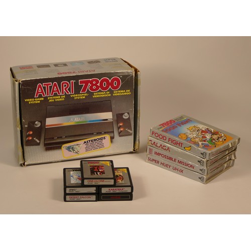 28 - Boxed Atari 7800 console, power supply unit, two mini stick controllers, TV lead including nine game... 