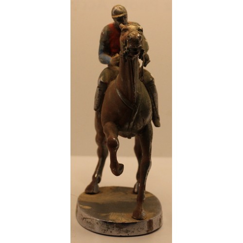 256 - A chrome and partially painted car mascot, by Louis Lejeune Ltd., in the form of a jockey on horseba... 