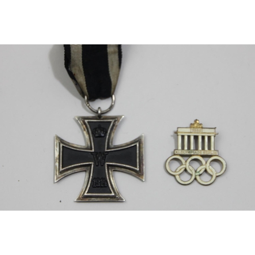 90 - A German WWI Iron Cross second class and a 1936 XI Olympiade Berlin white enamel badge (2)