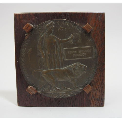 85 - A WWI Death penny, awarded to Percy William Piddock, mounted on an oak frame.