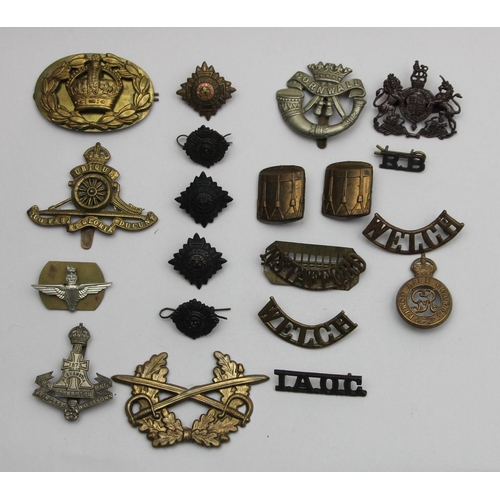 72 - A collection of cap badges and pips, including Cornwall, The Yorkshire Regiment and N. Stafford