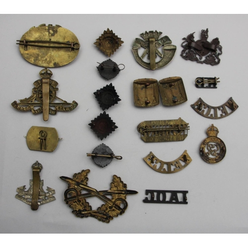 72 - A collection of cap badges and pips, including Cornwall, The Yorkshire Regiment and N. Stafford