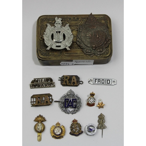 75 - A Queen Mary Christmas 1914 brass tin, together with a collection of cap badges, including the Argyl... 