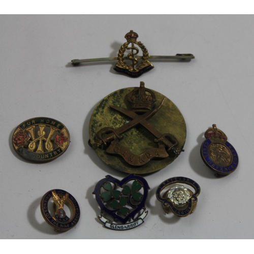 76 - A WWI Canadian physical instructors cap badge and other badges