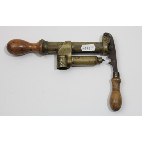 77 - A brass 12 bore shotgun cartridge maker machine, with fruitwood handles, the steel bar stamped 12 an... 