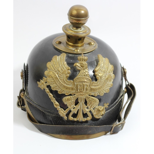 82 - A WWI German Artillery Pickelhaube, leather bodied helmet with brass Prussian Garde pattern helmet p...