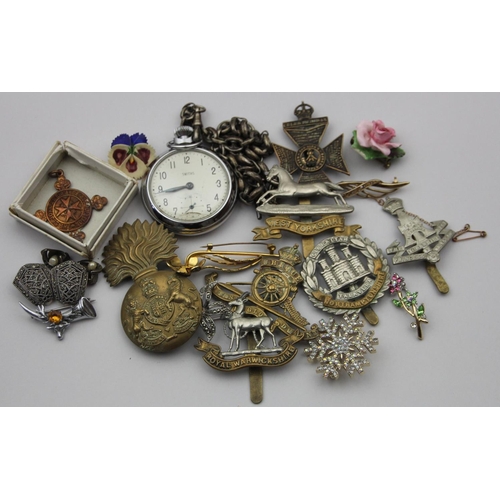 83 - A collection of cap badges, to include Fusiliers, and West Yorkshire and other items.