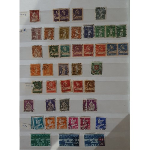 173 - A large collection of Swiss/Helvetia stamps, mainly used, and other loose stamps.