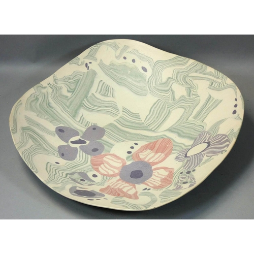 167 - Margery Clinton, a stoneware dish of irregular square form, painted with flowers and abstract patter... 