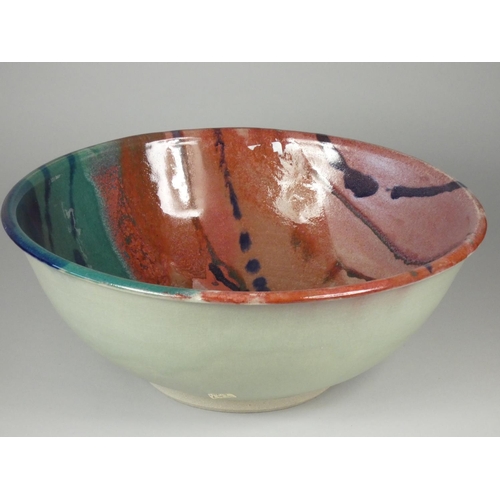 182 - Icehouse Pottery, a large circular stoneware bowl with red, blue and turquoise glaze, diameter 32 cm... 