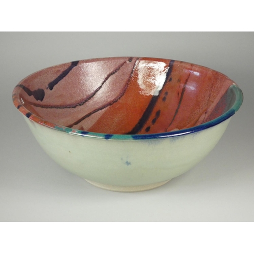 182 - Icehouse Pottery, a large circular stoneware bowl with red, blue and turquoise glaze, diameter 32 cm... 