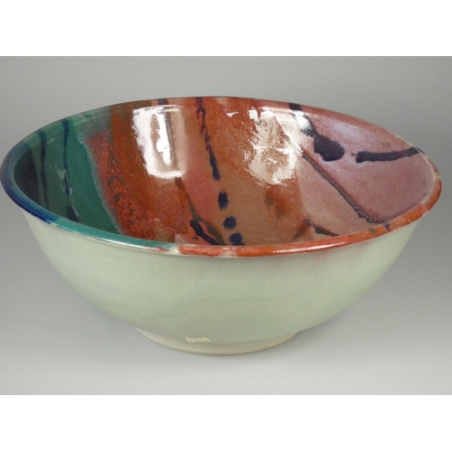 182 - Icehouse Pottery, a large circular stoneware bowl with red, blue and turquoise glaze, diameter 32 cm... 