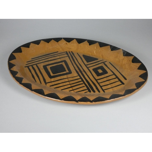 193 - Unknown, a brown glazed clay serving plate with black detail, diameter 40 cm