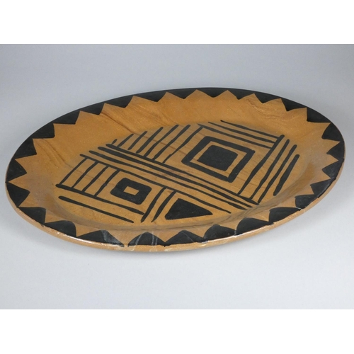 193 - Unknown, a brown glazed clay serving plate with black detail, diameter 40 cm