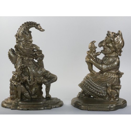 228 - A cast iron pair of door stops, in the form of Punch and Judy, later painted, 32 cm.